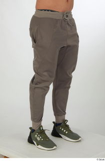 Joel dressed green sneakers grey jogger pants leg lower body…